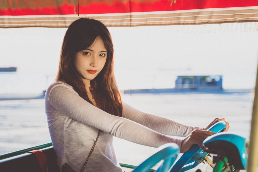 a-woman-riding-on-the-back-of-a-blue-motorcycle-g-oorvofbcw